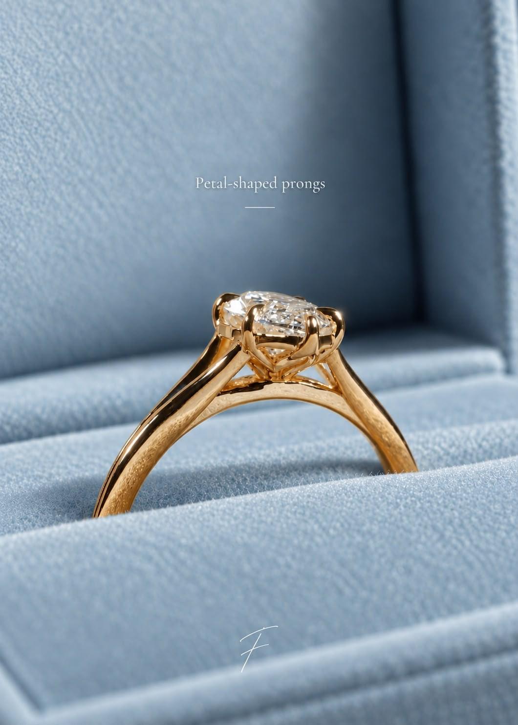 Side profile of the solitaire in a powder-blue box, showing petal-shaped prongs