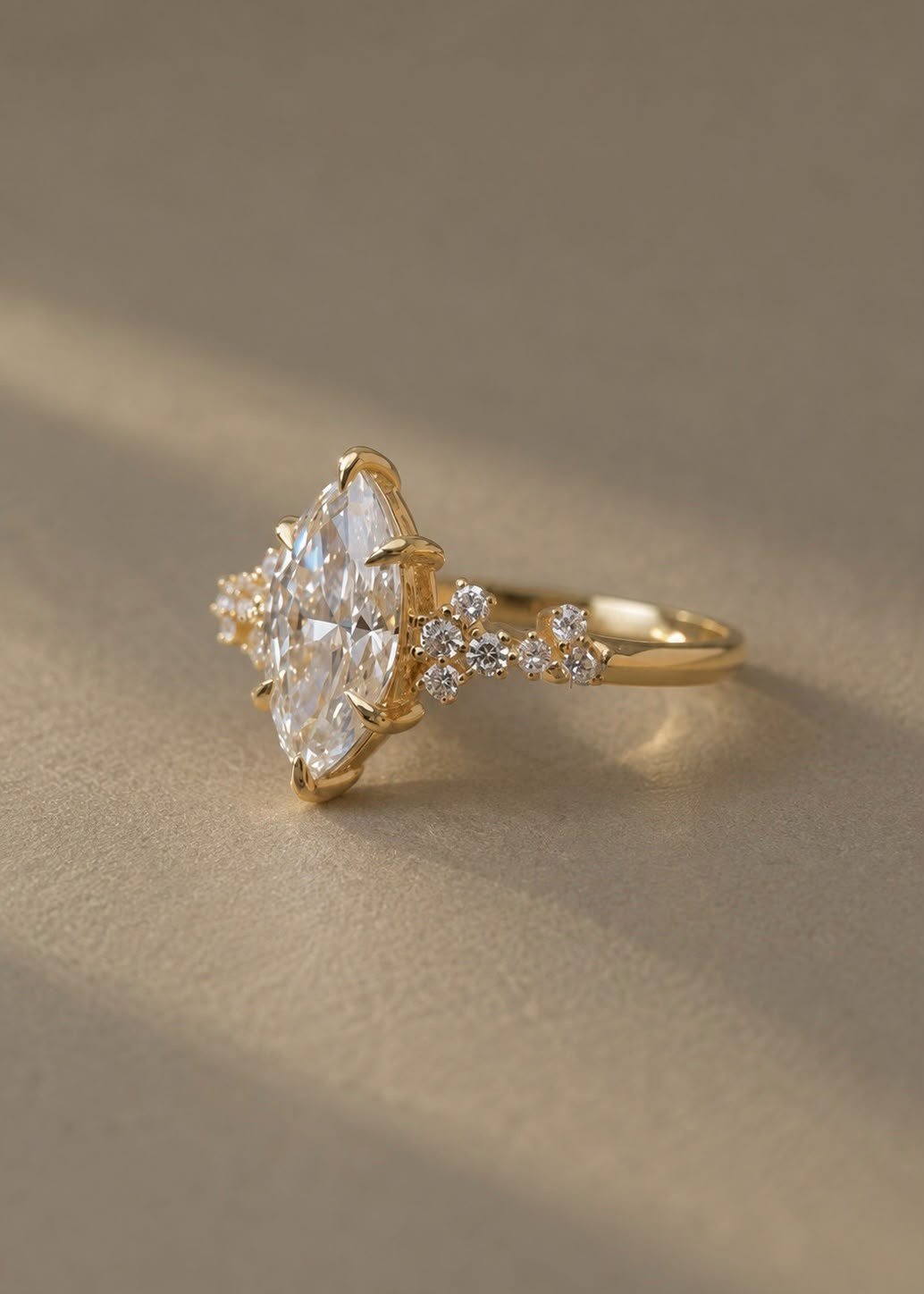 ANDËRR Ring lying on its side on warm sand-coloured texture in window light