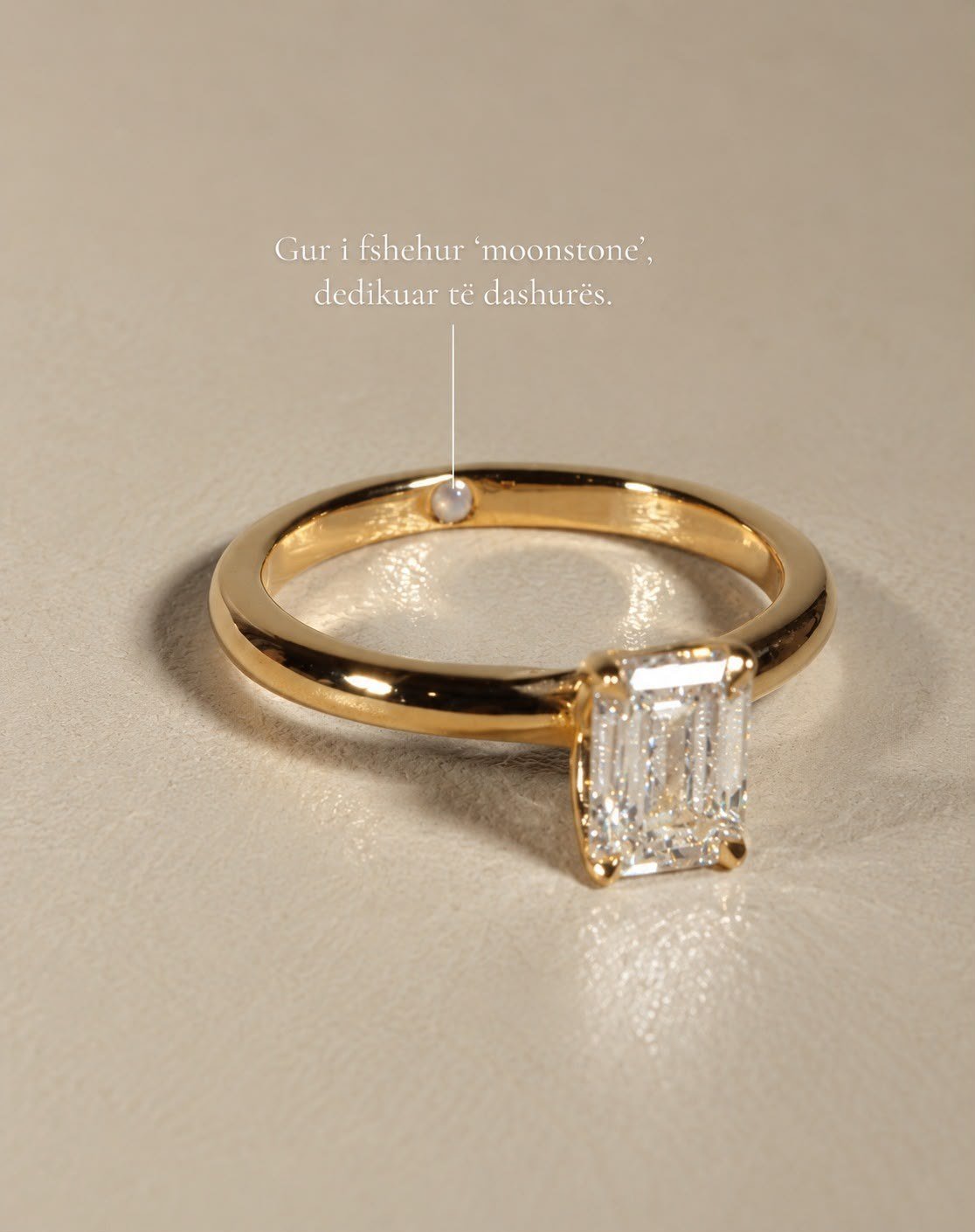 Emerald solitaire with a hidden moonstone set inside the band