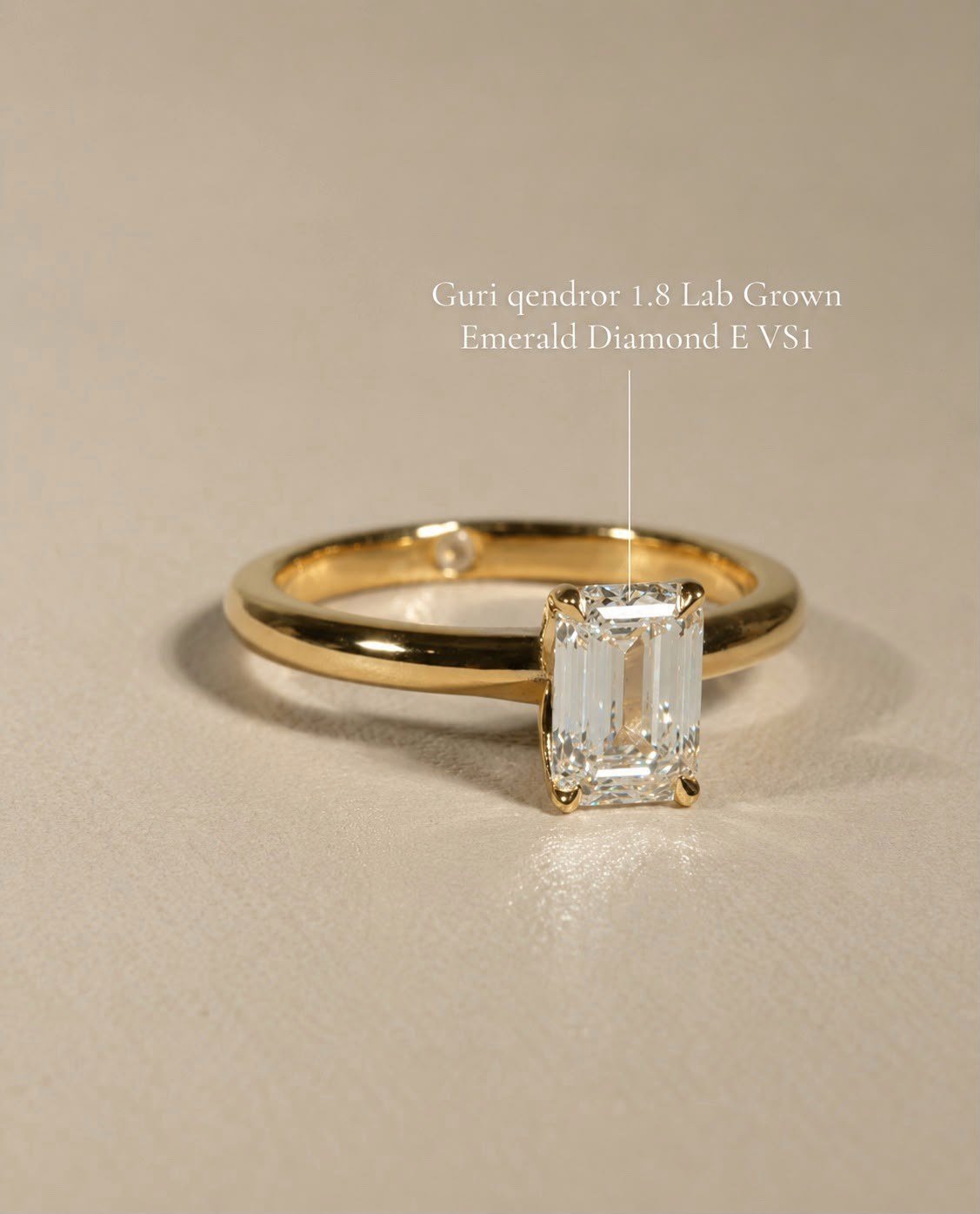 Emerald-cut lab-grown diamond solitaire in yellow gold on a warm sand surface