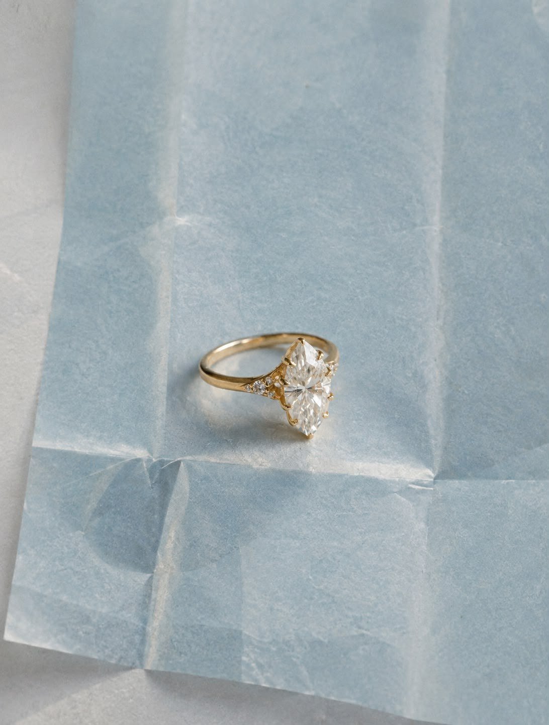 FATBARDHA marquise ring on folded pale blue tissue paper