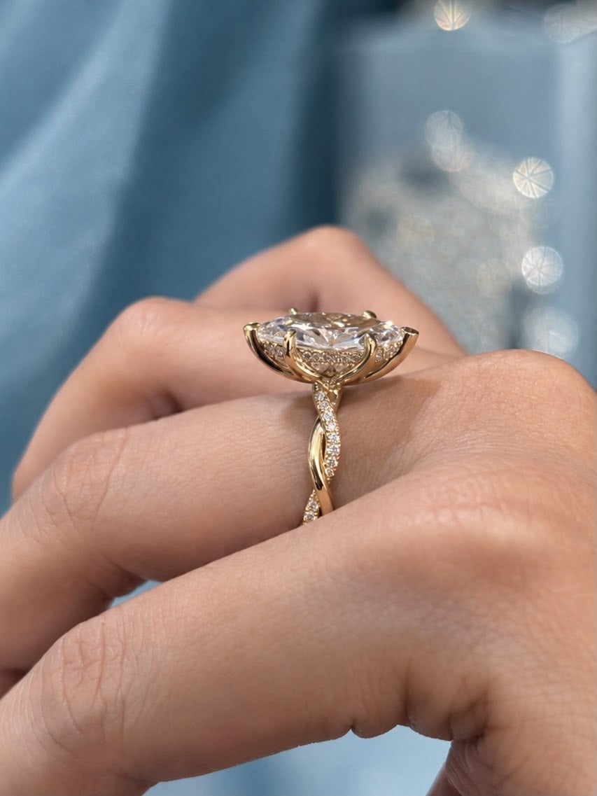 The Marquise worn on a hand, showing the twisted pavé band from the side