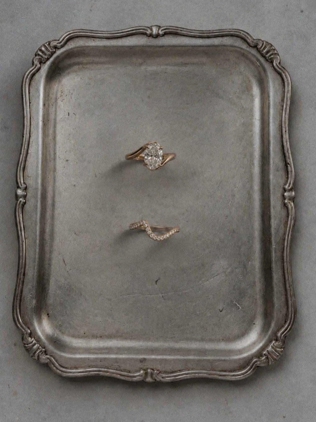 The Oval and its curved pavé band on an antique pewter tray
