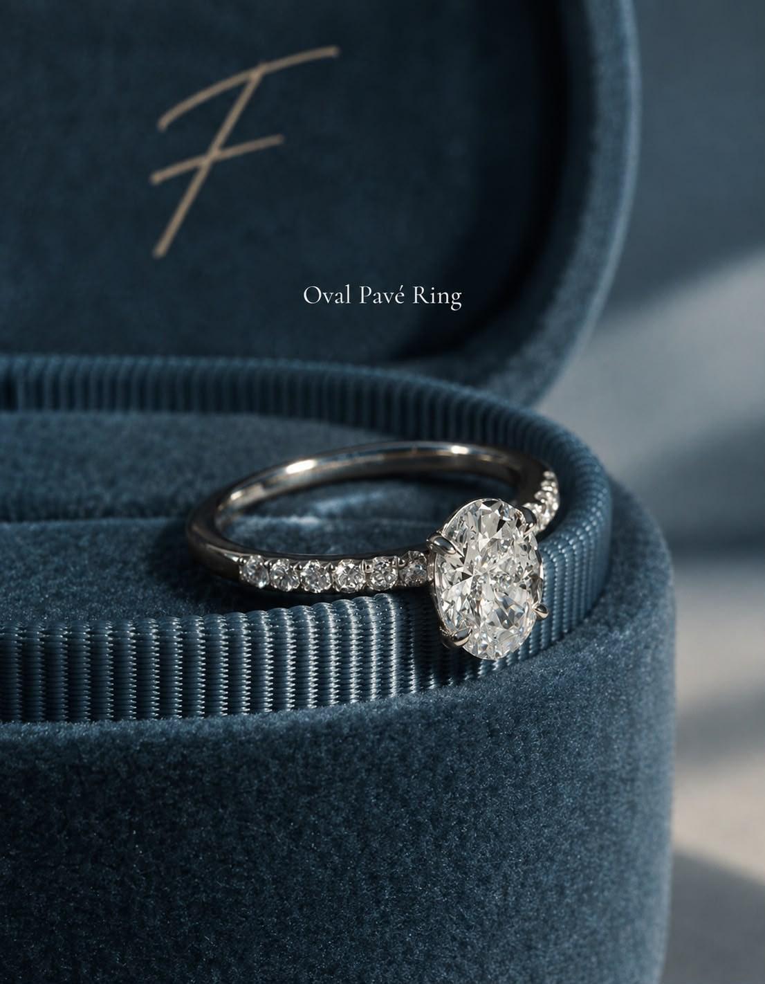 Oval Pavé Ring in 14k white gold resting on the rim of a petrol-blue velvet FLORA box